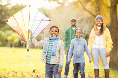 Young family playing with a kite