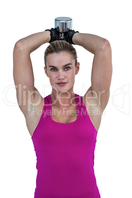 Muscular woman exercising with dumbbells