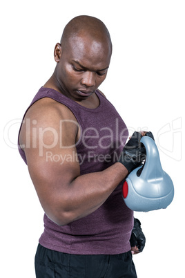 Fit man exercising with kettlebell