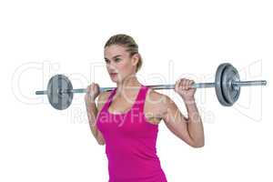 Sporty female bodybuilder lifting barebell