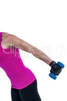 Muscular woman exercising with dumbbells