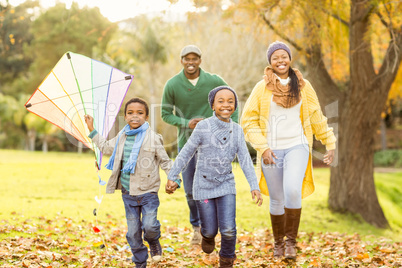 Young family playing with a kite