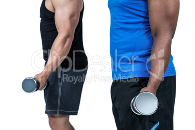 Strong friends posing with dumbbells