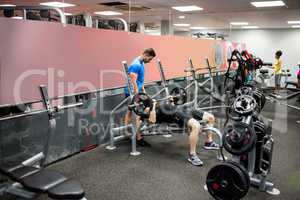 Fit people working out in weights room