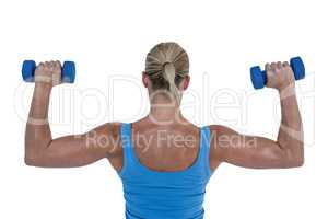 Rear view of muscular woman lifting dumbbells