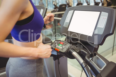 Fit woman jogging on treadmill