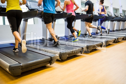 Fit people jogging on treadmills