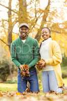 Portrait of a young couple holding leaves