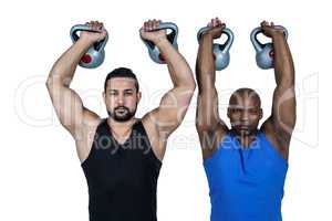 Strong friends lifting kettlebells together