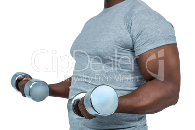 Fit man exercising with dumbbell