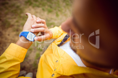 Man using his smartwatch on a hike