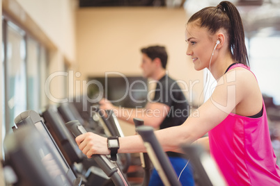 Fit people working out using machines