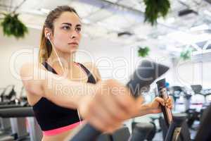 Focused woman on the cross trainer