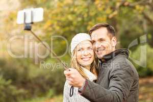 Smiling young couple taking selfies