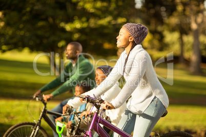 Side view of a young family doing a bike ride