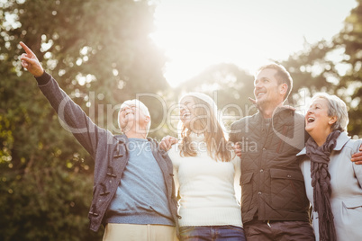 Smiling family looking away and pointing something