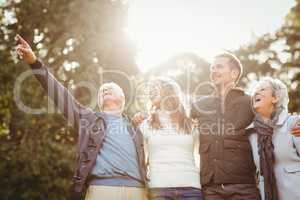 Smiling family looking away and pointing something