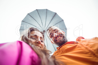 Happy couple under an umbrella