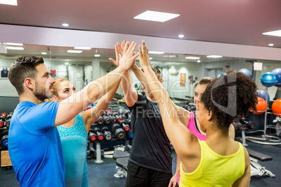 Fit people putting their hands together
