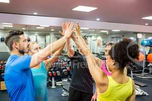 Fit people putting their hands together