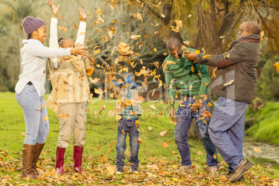 Happy family throwing leaves around