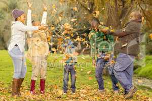 Happy family throwing leaves around