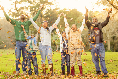 Happy family throwing leaves around