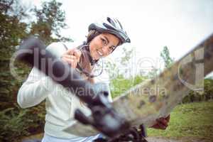 Happy woman on mountain bike reading map