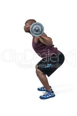 Fit man exercising with barbell