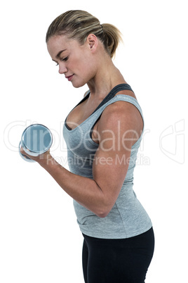 Muscular woman working out with dumbbells