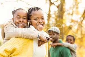 Portrait of a young smiling family in piggyback