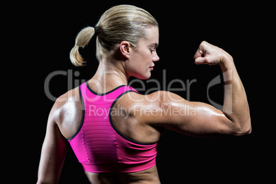 Muscular woman flexing her arm