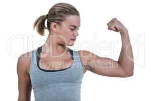 Serious muscular woman flexing muscle