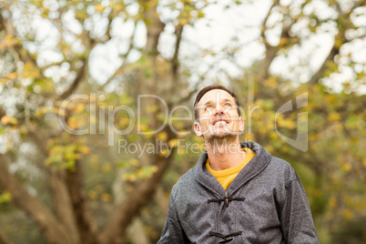 Young handsome man posing in park