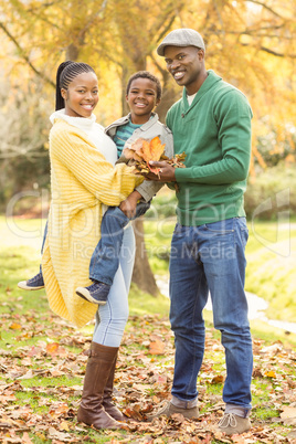 Portrait of a young smiling family holding leaves