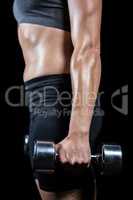 Muscular woman lifting heavy dumbbells