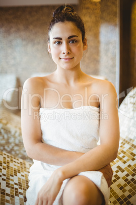 Woman sitting down wearing a towel