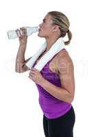 Muscular woman drinking water