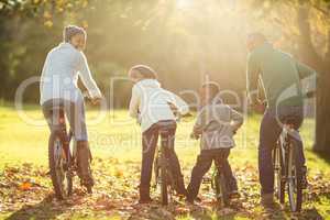 Rear view of a young family doing a bike ride