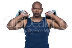 Muscular man exercising with kettlebell