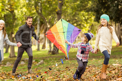 Young family playing with a kite