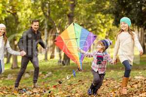 Young family playing with a kite