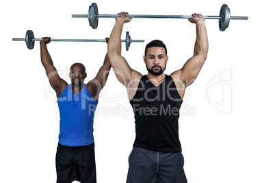 Man lifting barbell with trainer