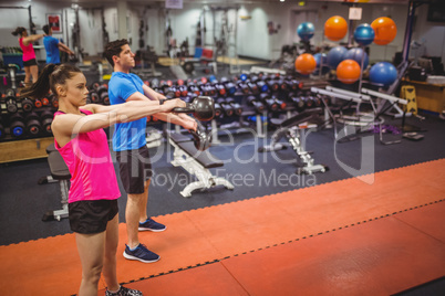 Fit couple working out in weights room