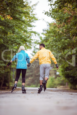 Happy couple roller blading together