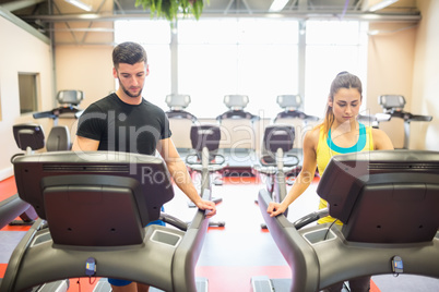 Man and woman using treadmills