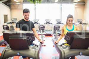 Man and woman using treadmills