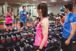 Fit couple working out in weights room