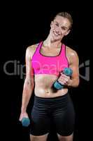 Muscular woman lifting heavy dumbbells