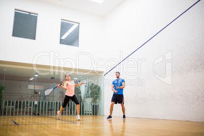 Couple playing a game of squash